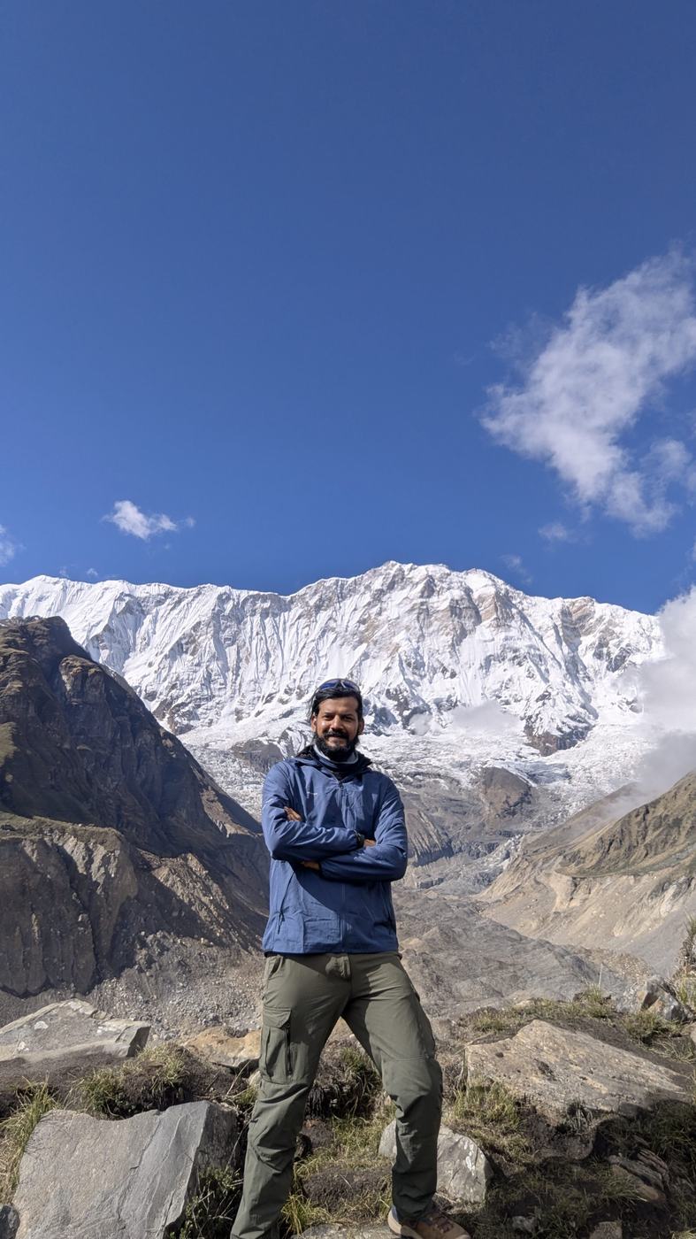 Standing below a large snow mountain