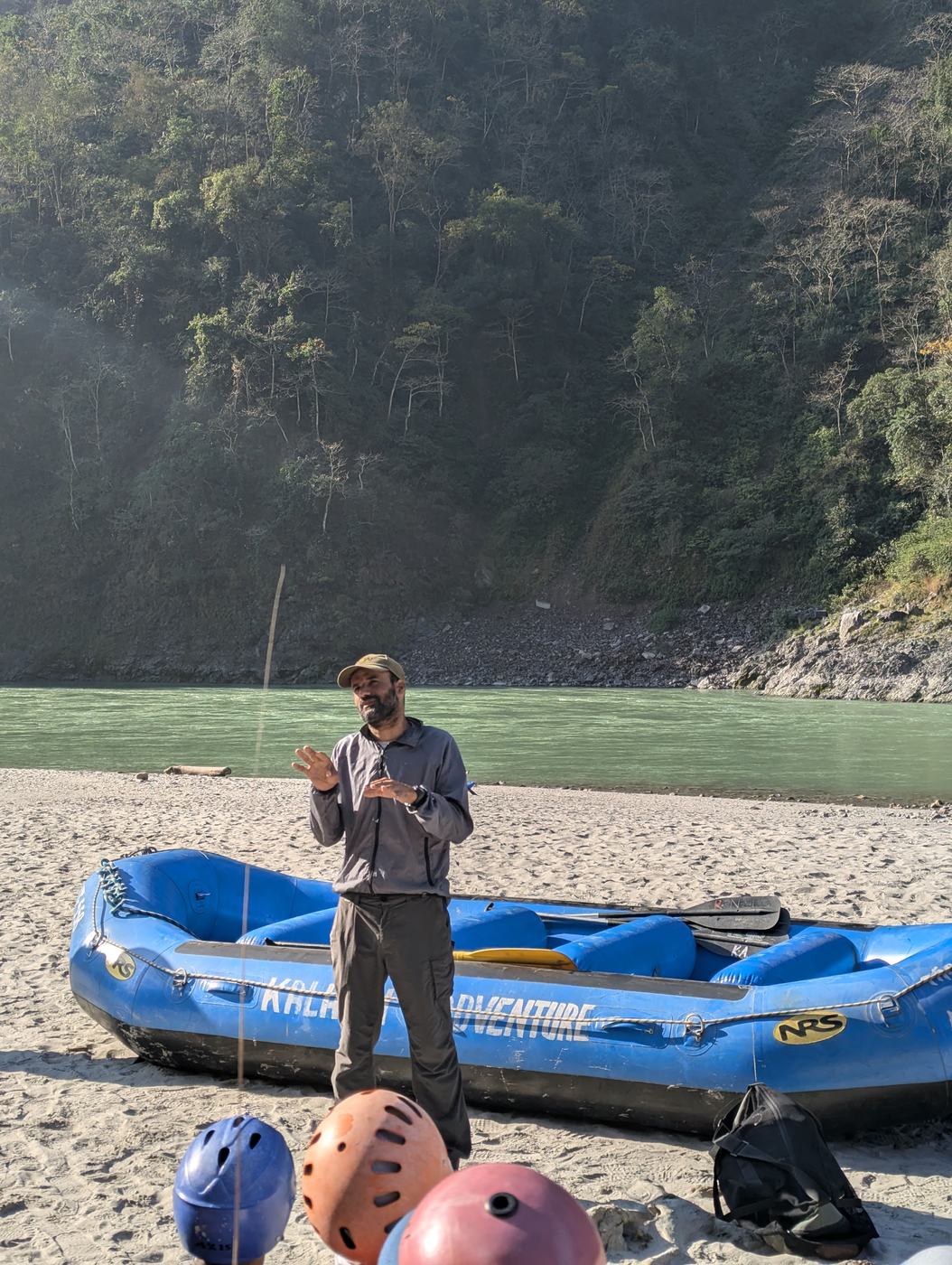 Rafts and helmets laid out on a river beach