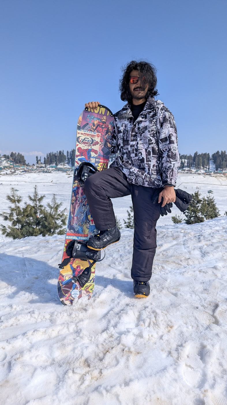Holding a snowboard in the snow