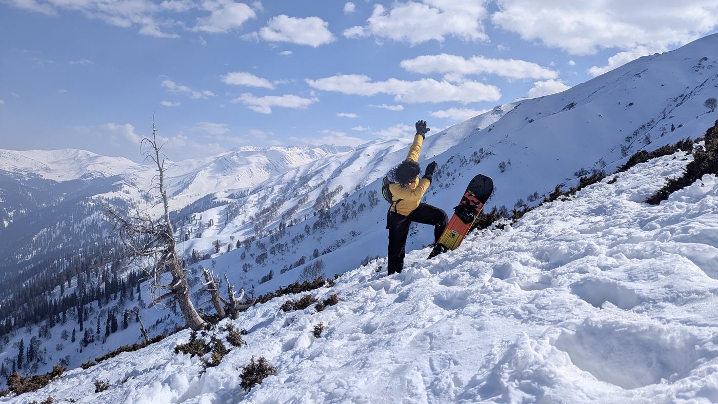 Snowboarder on a high ridge